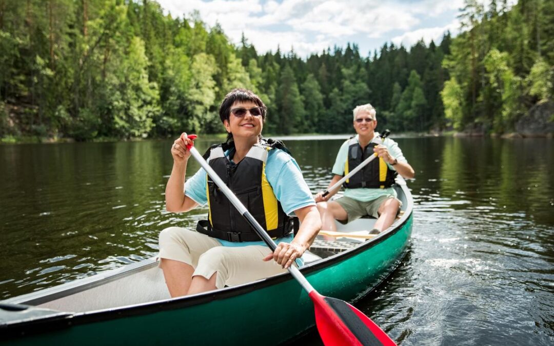 A couple on holiday taking a canoe ride.