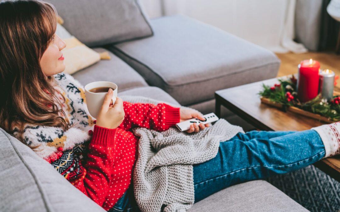 A woman relaxing wearing a Christmas jumper.