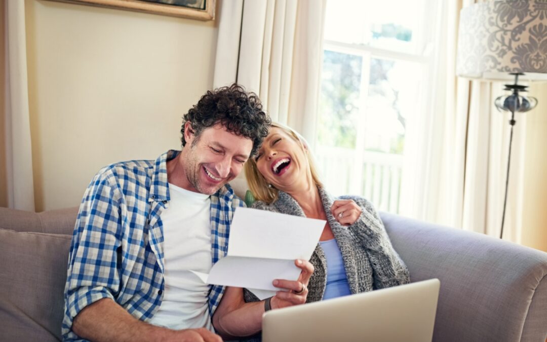A happy couple reviewing paperwork.