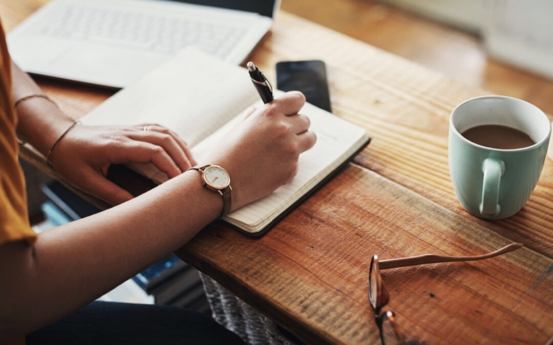 A woman making notes in a diary.