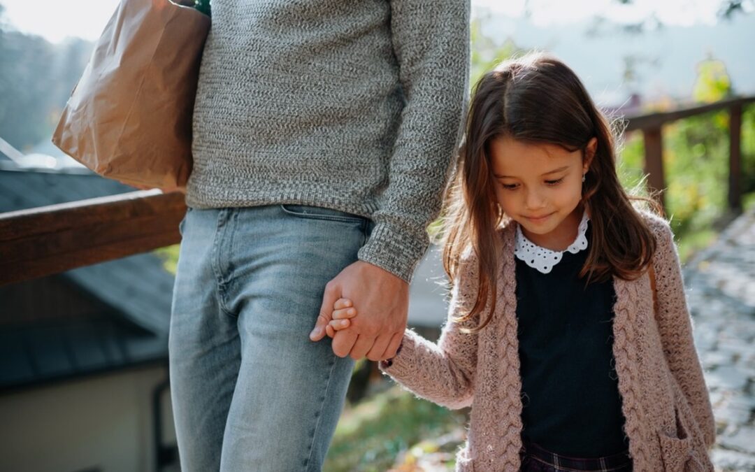 A mother and daughter holding hands.